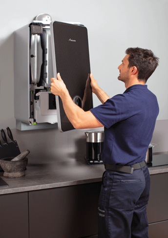 A man fixing the boiler