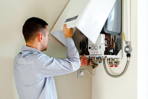 A Man fixing the boiler