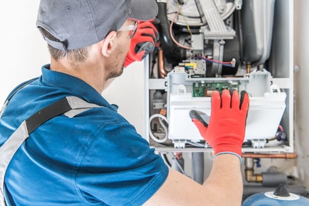 A Man fixing a boiler