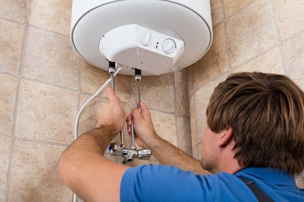 A man fixing water heater