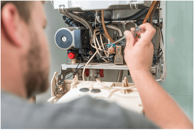 Man fixing combi boiler